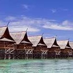 Tropical island resort on crystal clear water.